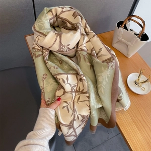 Close-up of thick autumn scarf featuring vintage floral branch print and soft frayed edges