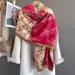 Detailed view of floral pattern and fringe edge on women's warm autumn knit shawl