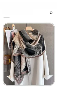 Detailed texture of printed imitation cashmere scarf with tassels on white coat