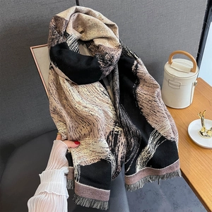 Close-up of thick winter scarf featuring abstract waves and fine tassel edge details