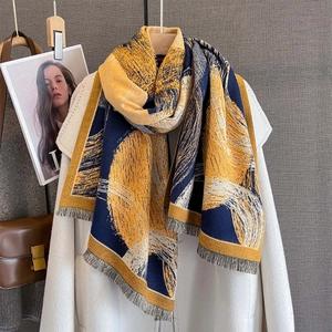 Close-up of thick navy and yellow abstract print scarf with soft fringe edges
