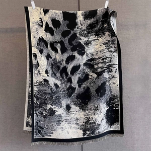 Dettaglio ravvicinato della trama dello scialle in maglia leopardata con frange fini