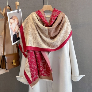 Detail view of paisley print scarf with fringe edge and autumn tricolor patchwork