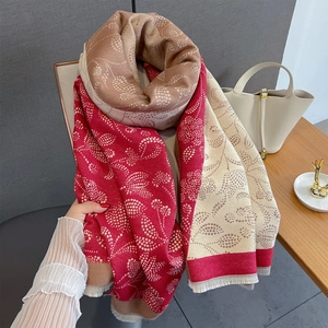 Detail of color-block scarf with paisley dots and delicate fringe tassels for autumn