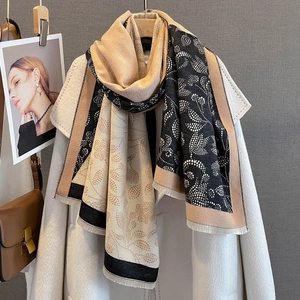 Detail of color-block scarf featuring vintage paisley floral prints and fringed edges