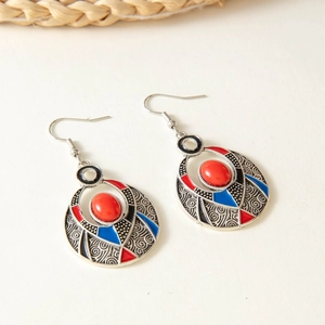 Detailed engraving on bohemian drop earrings with red stones and vintage floral patterns