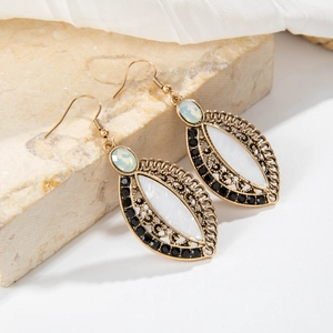 Detailed close-up of bohemian earrings with marble inlay and green opal stones