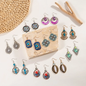 Flat lay of vintage bohemian earring set featuring colorful gems and floral carvings