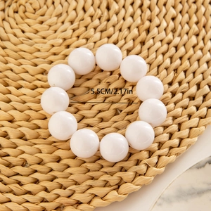 Macro shot of a 5.5cm diameter white beaded stretch bracelet with smooth round beads