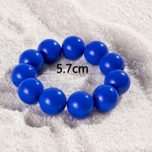 Detailed view of dark blue beaded bracelet with 5.7cm inner diameter on white sand