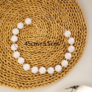 Detail of white chunky bead necklace with adjustable metal lobster clasp and extension chain