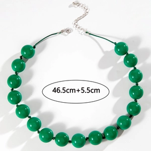 Detail of green beaded bohemian necklace with lobster clasp and adjustable silver chain