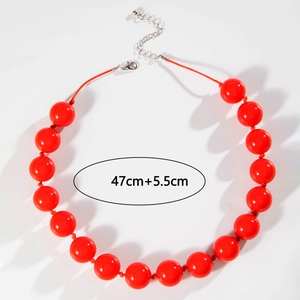 Macro shot of large red beads necklace with silver lobster clasp and extension chain