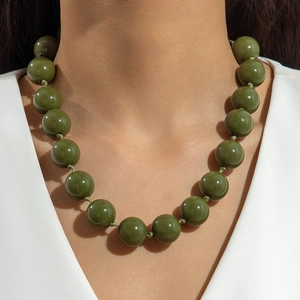 Detail of olive green polished large bead necklace showing glossy finish and knotting