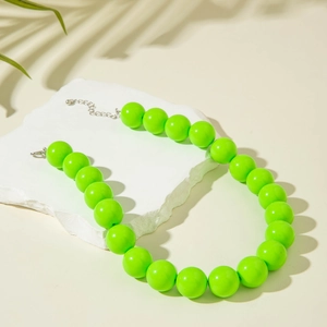 Detail of neon green oversized beaded necklace with silver adjustable lobster clasp