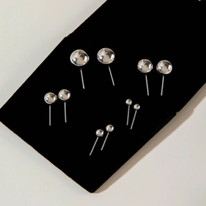 Set di orecchini a bottone a sfera in argento lucido in varie dimensioni su display