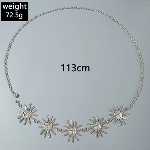 Detail of silver sun pendant body chain for beach wear with lobster clasp closure