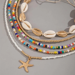 Detail of Bohemian shell and starfish multilayer beaded necklace and bracelet jewelry set