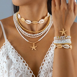 Detailed view of layered bohemian starfish shell necklace and beaded bracelet set