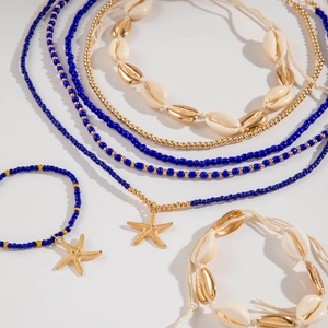 Detail of bohemian ocean jewelry set with blue beads, starfish charms and shell pendants