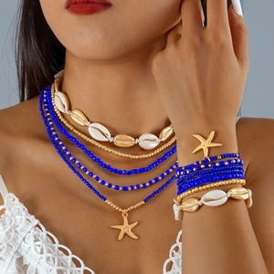 Bohemian multi-layer necklace and bracelet set with blue beads, starfish, and shells