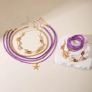 Detail of Bohemian beaded jewelry set featuring purple beads, shells and starfish charms