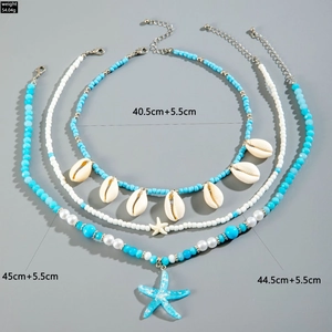 Detailed set of bohemian bead necklaces featuring natural shells and blue starfish charms