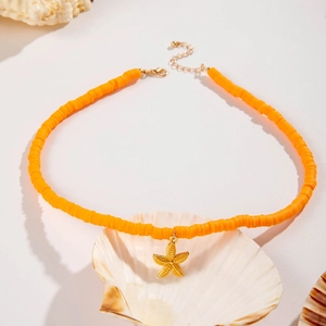 Bohemian orange beaded necklace with a golden starfish pendant on seashell background