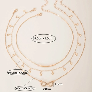 Detailed view of layered rose gold necklace with star charms and infinity pendant