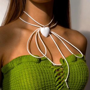 Close-up of white 3D heart pendant necklace with velvet ribbon on a model