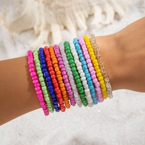 Close-up of bohemian seed bead bracelet set worn on wrist with 13 colorful rainbow layers