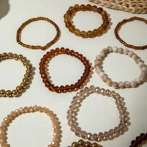 Detailed stack of Bohemian glass beads and metallic gold stretch bracelets