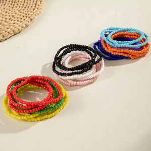 Close-up of stacked bohemian colorful beaded bracelets in a minimalist lifestyle setting