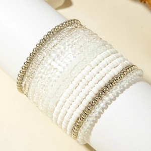 Close-up of bohemian multilayer beaded bracelet set with silver and translucent beads