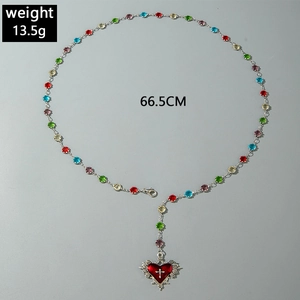 Detail of Y-shaped necklace with multi-color beads and red heart cross pendant