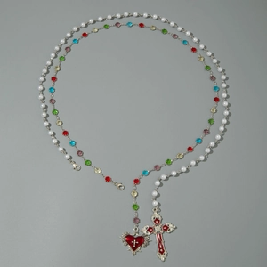 Detail of double-layer beaded long necklace with colorful glass beads and enamel cross charms