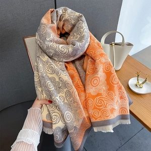 Detailed view of the vintage swirl pattern and fringe edges on a warm cashmere shawl
