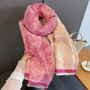 Detail of pink vintage scroll pattern pashmina with soft white fringe finish