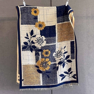 Close-up of cashmere-like scarf showing vintage floral patterns and fringe details