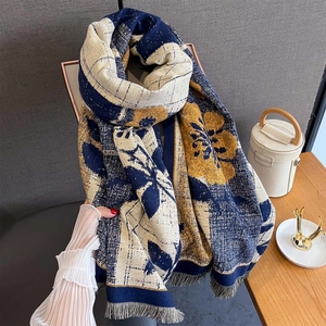 Detail view of thick autumn scarf showing floral plaid patterns and soft fringe texture