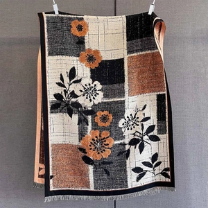 Detailed view of autumn cashmere-like scarf showing floral print and tassel edges