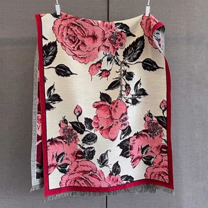 Detail of rose floral jacquard pashmina with fringed edges and soft cashmere-like texture