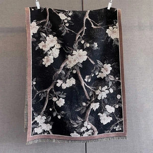 Detail of cashmere-feel scarf with floral print and decorative fringe edges
