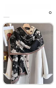 Detailed texture of imitation cashmere scarf with floral patterns and delicate tassels
