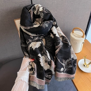 Detail of vintage floral print scarf with soft tassels and warm knit texture finish