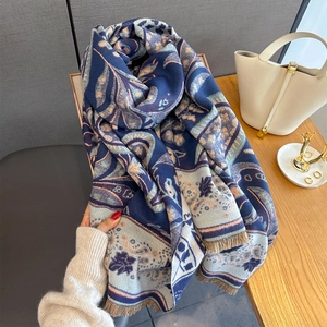 Detailed view of paisley cashmere scarf with fringe edges and ethnic patterns
