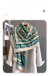 Detail of soft imitation cashmere scarf with geometric scroll patterns and fringe edges
