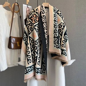 Close-up of geometric pattern scarf featuring fringe details and soft blended fabric