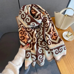 Detail of vintage geometric jacquard pattern with fringe on soft knitted scarf