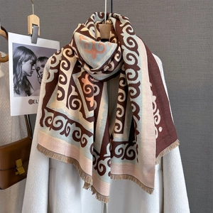 Ethnic geometric print scarf with tassels, warm winter shawl hung on white coat